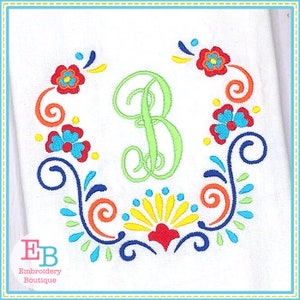 May include: Embroidered design featuring a green letter "B" surrounded by colorful floral and scroll motifs. The design is perfect for adding a personalized touch to a variety of projects.