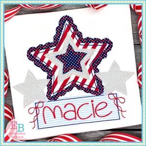 May include: A red, white, and blue star with a smaller star inside. The star is surrounded by a white border and has a scalloped edge. The name "macie" is embroidered in red on a blue and white striped banner.