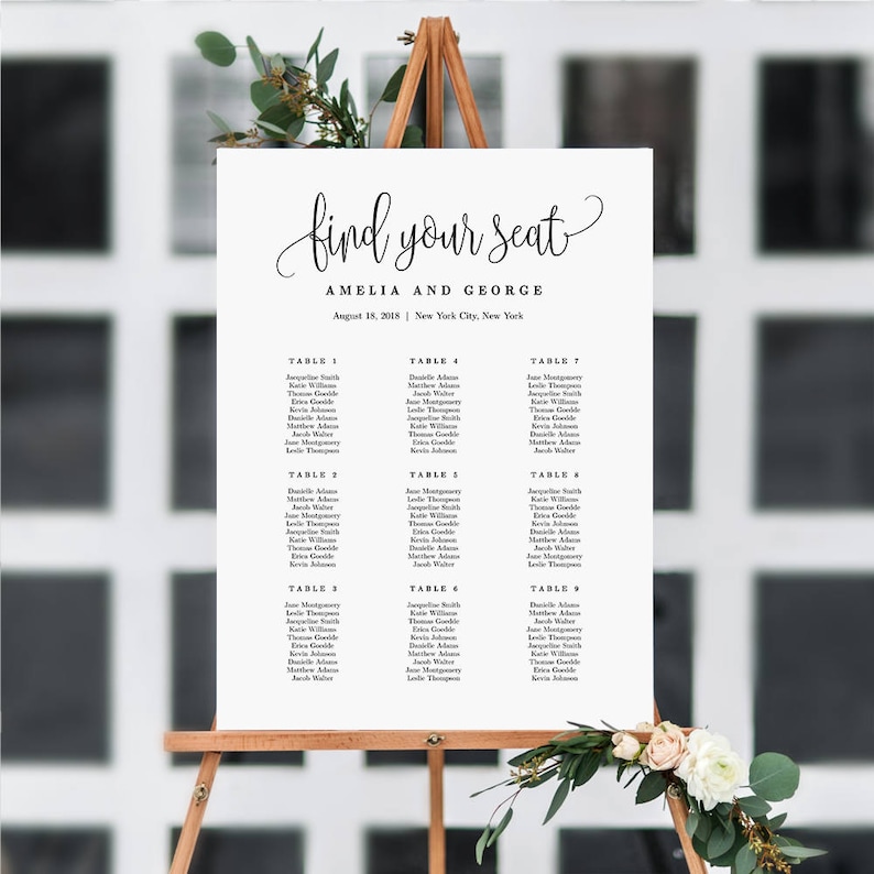 May include: A white wedding seating chart with black text. The chart is titled "Find Your Seat" and lists the names of guests at each table. The wedding is for Amelia and George and is taking place on August 15, 2015 in New York City.