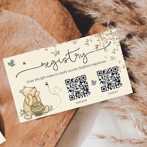 May include: Cream-colored registry card with the word "registry" in script. The card features a Winnie the Pooh illustration, QR codes for Amazon and Target, and the text "Scan the QR codes to easily access Sophia's registries."