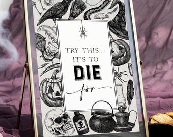 May include: A framed Halloween print with a gold-coloured metal frame. The black and white illustration features a raven, snake, witch's hat, pumpkin, skull, and potion bottle. The text reads "Try this... It's to die for."