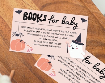 May include: Pink baby shower cards with Halloween-themed illustrations and text. The cards feature a ghost with a witch hat, a pumpkin, a spider, and the words "BOOKS for baby". The cards are on a wooden tray.