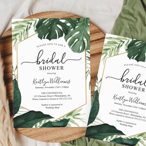 May include: Two white invitation cards with gold trim and green tropical leaf designs. The text on the cards reads "Please join us for a bridal shower honoring Kaitlyn Williams. Saturday, November 23rd, 2:00pm. The Continental, 123 Chestnut Street, Philadelphia, PA. Please respond to Jessica at 555.212.1212. Sophia is registered at Wedding Shop."