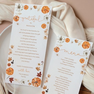 May include: Thanksgiving menu and place card set. The place card reads "grateful for Mason" with a poem. The menu lists a first course, main course, side dishes, and dessert. Both cards feature pumpkins and fall leaves.
