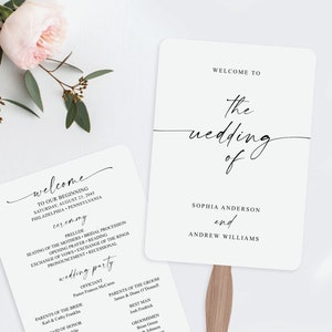 May include: A white wedding programme fan with black text. The fan features the names Sophia Anderson and Andrew Williams, along with the wedding date and ceremony details. The text "Welcome to the wedding of" is at the top of the fan.