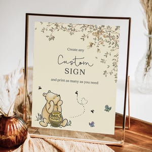 May include: A custom sign in a clear frame with a Winnie the Pooh illustration. The sign reads "Create any Custom SIGN and print as many as you need." The illustration includes bees, butterflies, and a honey pot.