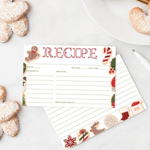Peut inclure: Une carte de recette avec le mot "RECIPE" en script rouge, orn&eacute;e de bonhommes en pain d'&eacute;pices et de cannes en sucre. La carte comporte des lignes pour les ingr&eacute;dients et les instructions. Une enveloppe lign&eacute;e assortie est &eacute;galement pr&eacute;sente, ainsi que des biscuits en forme de c&oelig;ur saupoudr&eacute;s de sucre glace.