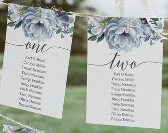 May include: Six table cards with floral designs and names of guests for a wedding reception. The cards are numbered one through six and are hanging from a string.