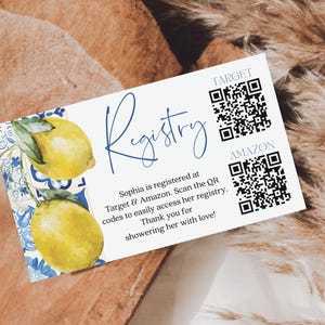 May include: Registry card with watercolor lemons and blue floral accents. The card includes the word "Registry" in elegant script, along with QR codes for Target and Amazon. Text invites guests to access the registry and thank them for showering with love.