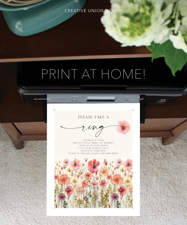 May include: A printable card with a floral background and the text "Please take a ring and hold it tight. Try not to say "bride" or "wedding" with all of your might. If you hear someone say it, snatch up their ring. To win at the end, collect the most bling."