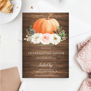 May include: Thanksgiving dinner invitation with a watercolor orange pumpkin and floral arrangement on a rustic wood background. The invitation text reads "Thanksgiving Dinner" and includes the date, time, and host's information.