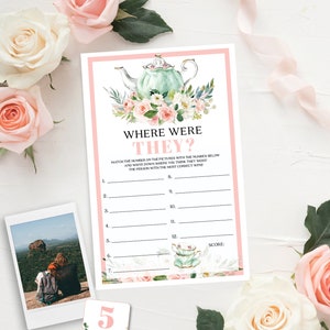 May include: A printable bridal shower game card with the text "WHERE WERE THEY?" featuring a watercolor teapot and floral design. The card is surrounded by pink and white roses, a photo, and a number 5 card.