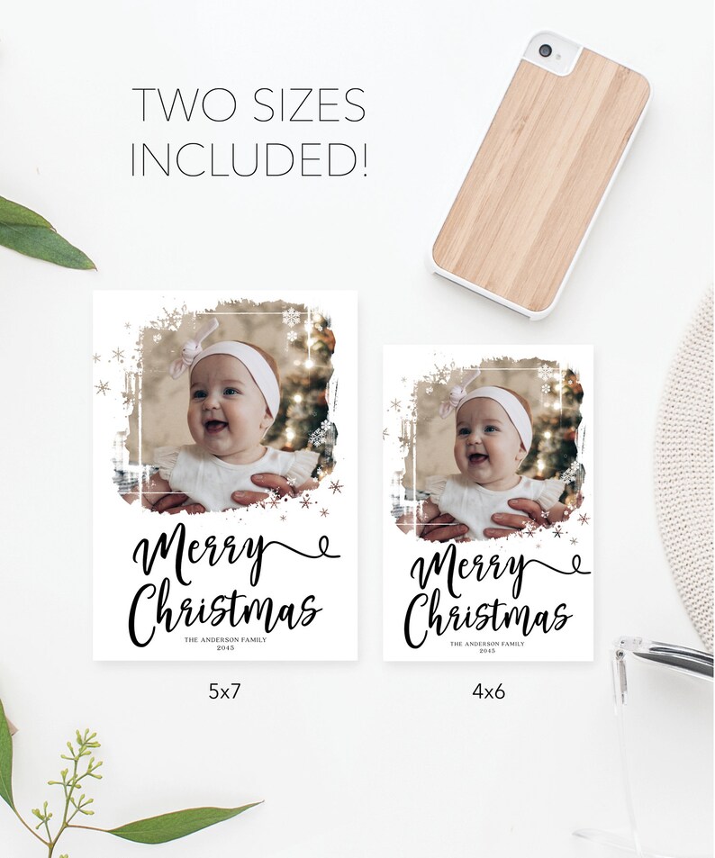 May include: Two Christmas photo cards with a baby's photo, framed with snowflakes and a distressed border. The cards read "Merry Christmas" in elegant script. One card is 5x7 inches, the other is 4x6 inches.