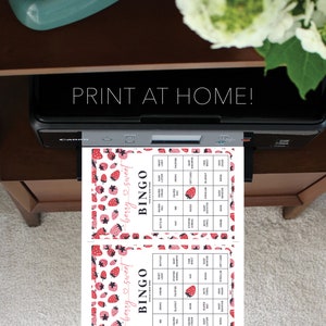 May include: Two printable bingo cards with a strawberry and heart design. The cards have a title that says "berry sweet bingo". The cards are filled with words related to baby showers.