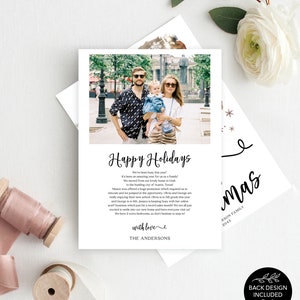 May include: A white holiday card with a family photo and the text "Happy Holidays." The card includes a family photo and a message from the family. The card also has a back design included.