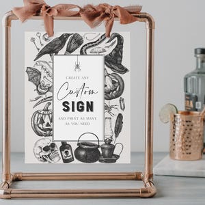 May include: A copper-colored metal frame holds a custom sign with Halloween-themed illustrations. The sign features a raven, witch hat, pumpkin, and spider, with the text "Create Any Custom Sign" and "Print as many as you need."