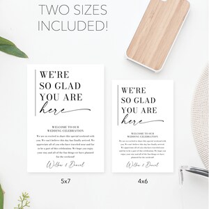 May include: Two printable wedding welcome signs in black and white with the text "We're so glad you are here" and a handwritten "here". The signs are shown in two sizes: 5x7 inches and 4x6 inches. The text includes a welcome message to guests and the names "Willow & Dancel".