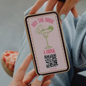 May include: A pink and white striped phone screen with the text "Buy the Bride a Drink" and a cartoon margarita glass. A QR code is below the text with the words "Scan Here".