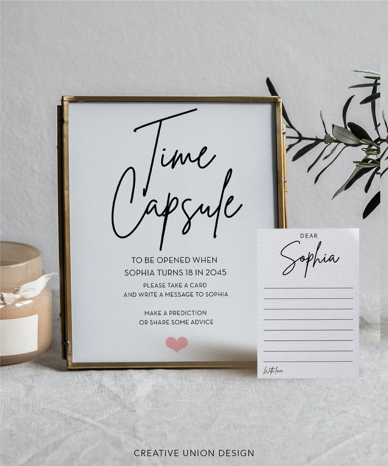 May include: A white sign with black text that reads "Time Capsule" and instructions to be opened when Sophia turns 18 in 2045. The sign also includes a pink heart and the text "Creative Union Design".