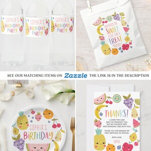 May include: A set of fruit-themed party supplies featuring a colorful design with smiling fruit faces. The set includes a water bottle label, a favor bag, a plate, and a thank you card. The text on the items reads "Sophia's Birthday" and "Birthdays are Sweet, Please Take a Treat".