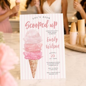 May include: A rectangular bridal shower invitation card featuring a pink and white vertical striped background. The card displays a watercolor illustration of a three-scoop ice cream cone and text reading She's Been Scooped up, Emily Wilson, August 23, 2:00-4:00PM, The Franklin Fountain, 23 Chestnut Street, Philadelphia, PA, RSVP to Jessica at 555.212.1212, and Emily is registered at Wedding Shop.