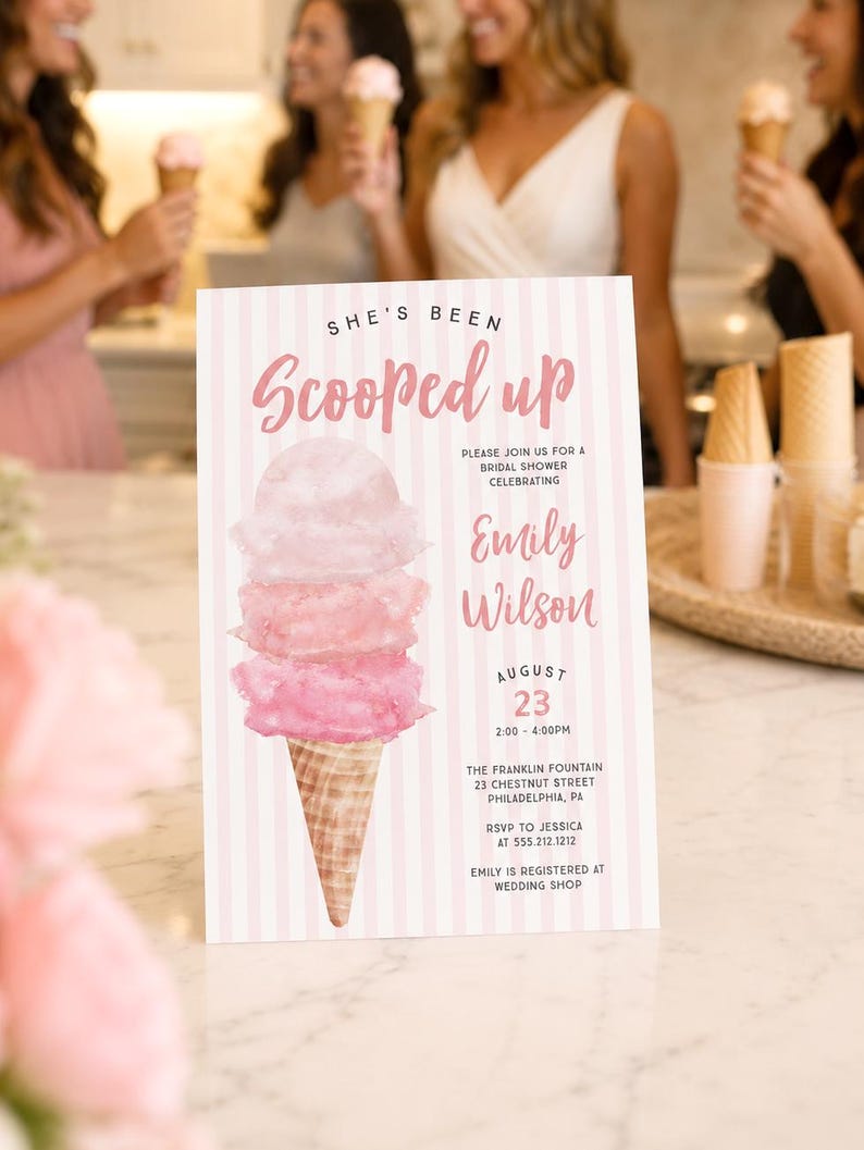 May include: A rectangular bridal shower invitation card featuring a pink and white vertical striped background. The card displays a watercolor illustration of a three-scoop ice cream cone and text reading She's Been Scooped up, Emily Wilson, August 23, 2:00-4:00PM, The Franklin Fountain, 23 Chestnut Street, Philadelphia, PA, RSVP to Jessica at 555.212.1212, and Emily is registered at Wedding Shop.