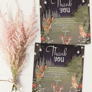 May include: Thank you card with a woodland theme. The card features a deer, a rabbit, mushrooms, and stars against a dark blue background. The text on the card reads "Thank you" and "Sophia".