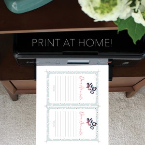 May include: Printable cards with a light blue background and white flowers. The cards have the text "Dear Annabelle" and a line for writing. The text "With Love" is at the bottom of the card.