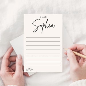May include: A white card with black text that reads "Dear Sophia" and has lines for writing. The card also has the text "With love." at the bottom.
