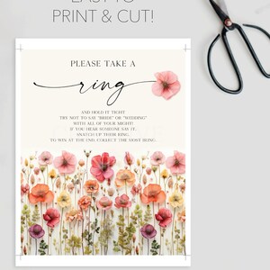 May include: A printable game card with a floral background and the text "Please take a ring and hold it tight. Try not to say "bride" or "wedding" with all of your might! If you hear someone say it, snatch up their ring. To win at the end, collect the most bling."