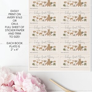 May include: Set of eight printable bookplate labels featuring a woodland theme with a brown bear, deer, and other forest elements. Each label is 2 inches by 4 inches and says "baby's first library" with a space to write "given with love by:"