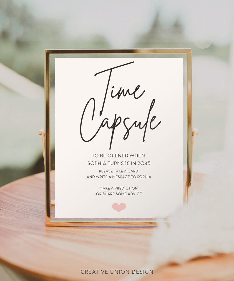 May include: A gold-framed sign with the text "Time Capsule" and instructions to write a message for Sophia to be opened when she turns 18 in 2045.