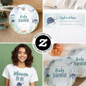 May include: A set of baby shower party supplies featuring a watercolour design of sea creatures, including a turtle, octopus, jellyfish, and fish. The design is on a light blue background with white bubbles. The text "Baby Shower" is written in teal green lettering. The text "Jessica & Daniel's" is written in black lettering. The text "01.23.XX" is written in black lettering. The text "Mama To Be" is written in teal green lettering on a white t-shirt. The text "Sophia Anderson" is written in teal green lettering on a light blue background with a watercolour design of a turtle. The text "234 Chestnut Street, Philadelphia, PA 12345" is written in black lettering.