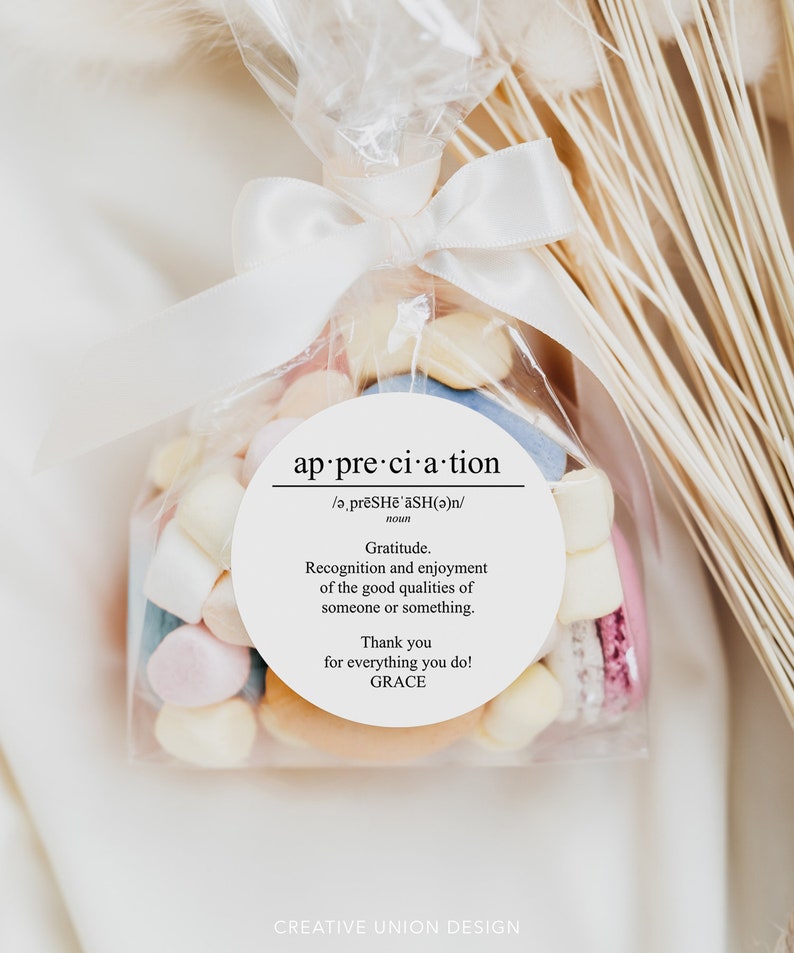 May include: A white favor bag filled with colorful candies and macarons. A white circle sticker with the word "appreciation" and a definition of the word is attached to the bag. The sticker also includes the text "Thank you for everything you do! GRACE".