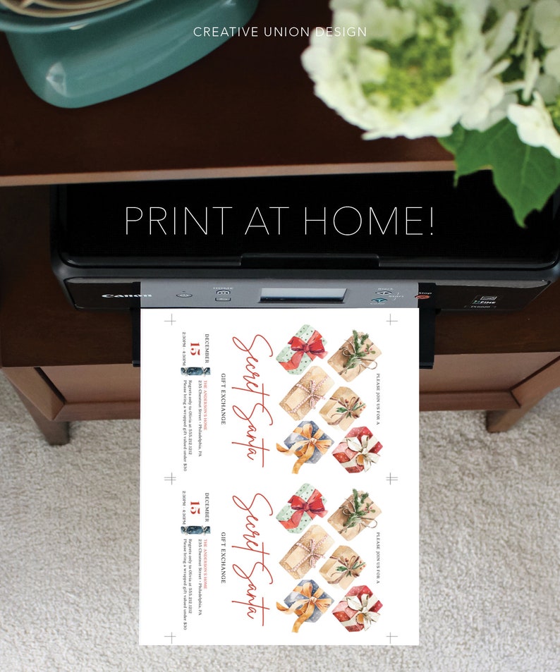 May include: A black printer outputting a white sheet of paper with two identical Secret Santa gift exchange invitations. The invitations feature watercolor illustrations of wrapped presents with red, blue, and tan ribbons and text detailing a December 15 event.