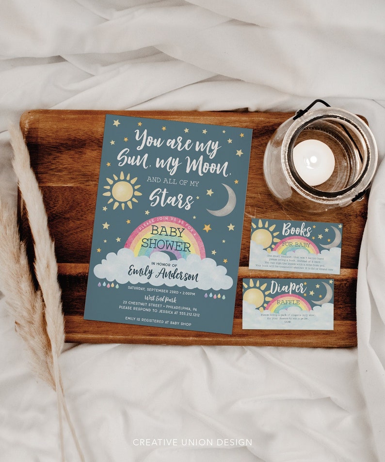 May include: A baby shower invitation with a blue background and a rainbow with clouds. The text reads "You are my Sun, my Moon, and all of my Stars." The invitation also includes the name "Emily Anderson" and the date and time of the shower.