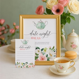 May include: A framed print with the words "date night ideas" and a matching card, both featuring a teapot illustration and floral accents. A teacup, saucer, and a vase of roses complete the scene.