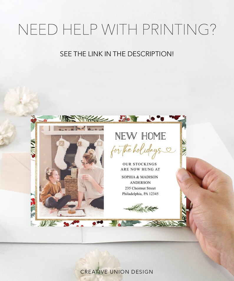 May include: A holiday-themed card with a photo of a family in front of a fireplace. The card features text that reads "New Home for the Holidays" and includes the family's names and address. The card is decorated with festive greenery.