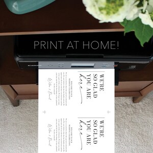 May include: Printable wedding sign with the text "We're so glad you are here" in black script font on a white background. The sign is designed for a wedding celebration and includes the names "Willow & Daniel".
