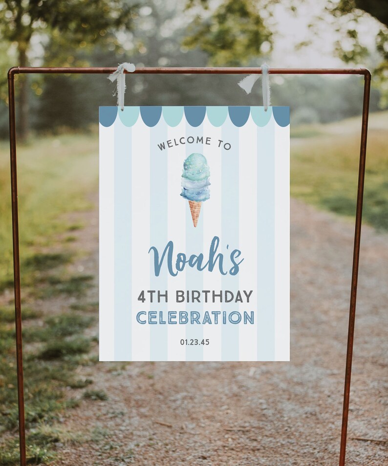 May include: Welcome to Noah's 4th Birthday Celebration sign with a blue and white striped background and an illustration of an ice cream cone with blue and white ice cream. The sign also includes the date 01.23.45.