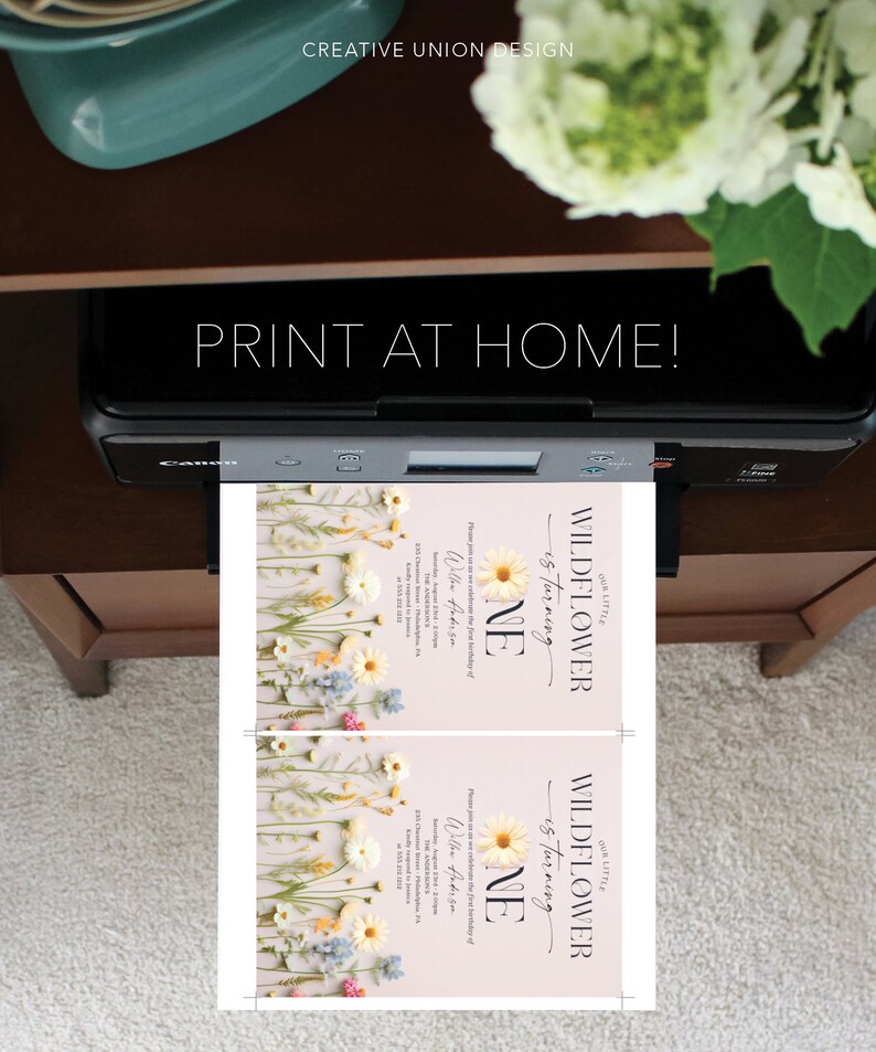 May include: Printable invitation for a first birthday party with a floral theme. The invitation features a light pink background with a floral border and the text "Our Little Wildflower is turning One" in black text. The invitation also includes the child's name and the date of the party.
