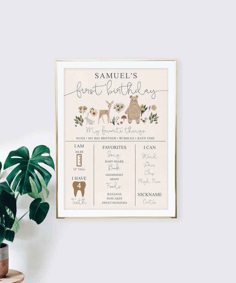 May include: A printable first birthday chart for a boy named Samuel. The chart features a woodland theme with a brown bear, deer, and other forest animals. It includes details about the child's age, weight, height, favorite things, and skills. The chart is decorated with a floral border.