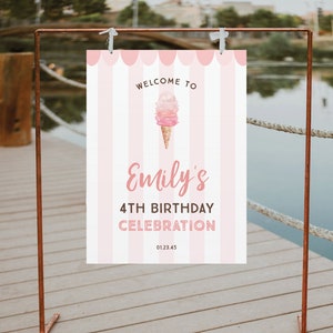May include: A pink and white striped sign with the text "Welcome to Emily's 4th Birthday Celebration" and an ice cream cone graphic. The sign is hanging from a copper-colored metal frame, perfect for a birthday party.