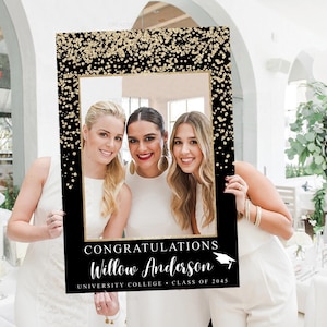 May include: Black and gold photo booth prop with gold glitter and a white frame. The text reads "Congratulations Willow Anderson University College Class of 2045".