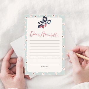 May include: A light blue stationery card with a white floral pattern and a strawberry illustration. The card has lines for writing and says "Dear Annabelle." at the top and "With Love." at the bottom.