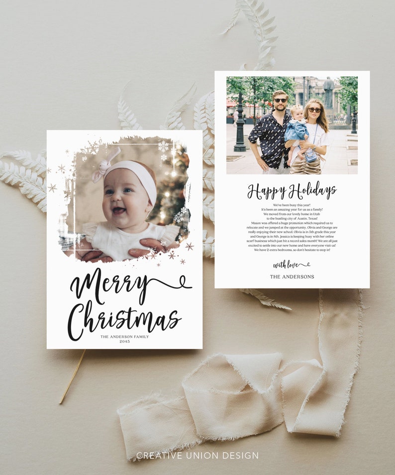 May include: A set of two holiday cards. One card features a baby's photo with "Merry Christmas" in elegant script. The other card has a family photo with "Happy Holidays" and a personal message. Both cards have a white background.