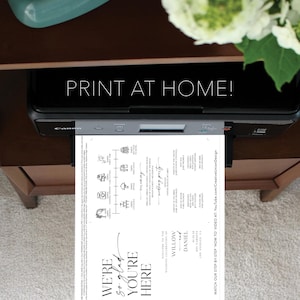 May include: A black Canon printer printing a wedding invitation with the text "PRINT AT HOME!". The invitation is white with black text and graphics, including the words "WE'RE so glad YOU'RE HERE". The design includes a timeline and the names Willow and Daniel.