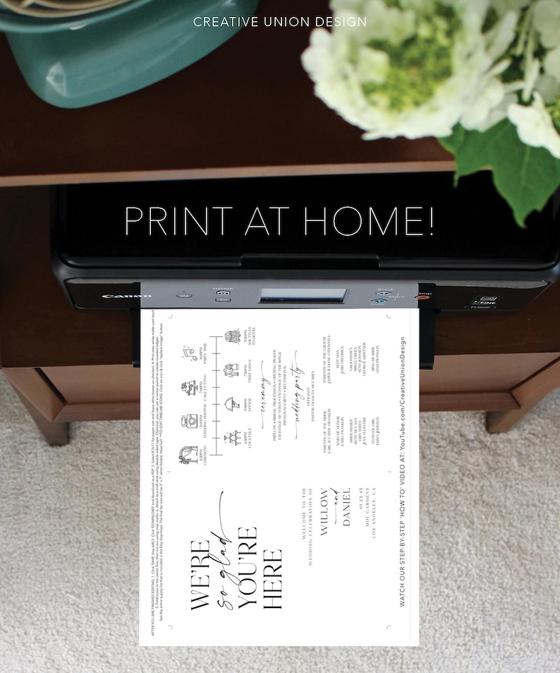 May include: A black Canon printer printing a wedding invitation with the text "PRINT AT HOME!". The invitation is white with black text and graphics, including the words "WE'RE so glad YOU'RE HERE". The design includes a timeline and the names Willow and Daniel.