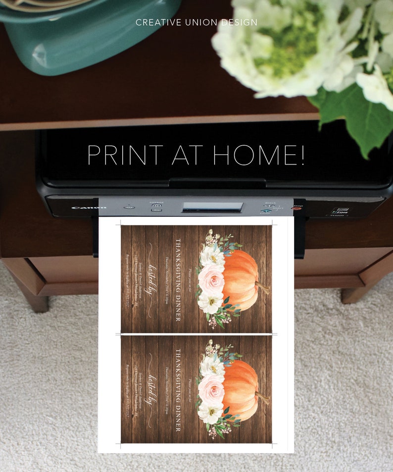 May include: A printer is shown printing two Thanksgiving dinner invitations. Each invitation features an orange pumpkin with floral accents on a wooden background. The text "PRINT AT HOME!" is visible above the printer.