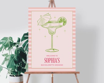 May include: Pink and white striped welcome sign with a green margarita glass and the text "Welcome to Sophia's Bachelorette Weekend".